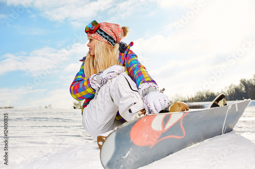 blonde snowboarder girl on snow