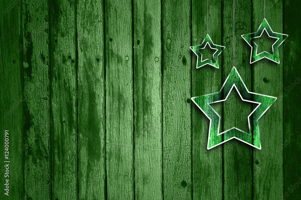 Naklejka premium Abstract green wooden background with illustrated glass effect Christmas and New Year Holiday decoration star shapes hanging on string. Xmas decoration with copy space background.