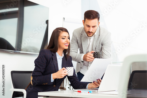 Business couple working together on project at modern office