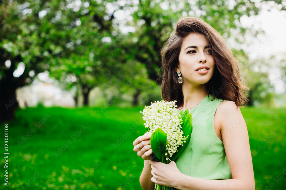 beautiful woman holding a bunch of flowers with lily of the vall beautiful woman holding a bunch of flowers with lily of the vall