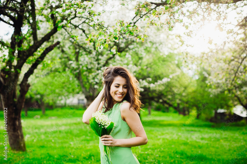 beautiful woman holding a bunch of flowers with lily of the vall beautiful woman holding a bunch of flowers with lily of the vall