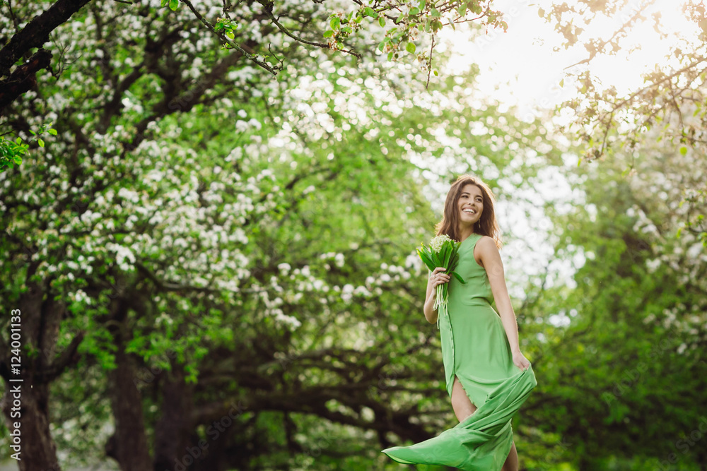 beautiful young woman standing in a green garden beautiful young woman standing in a green garden