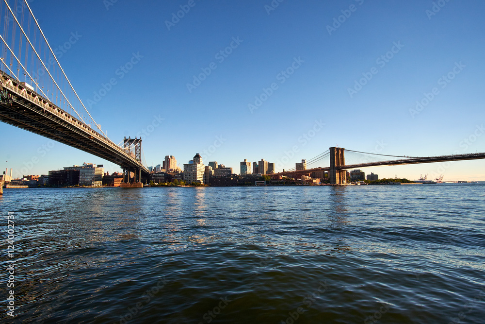 Fototapeta premium Standing between the Manhattan and Brooklyn Bridge looking over the East River from the area Two Bridges on Manhattan