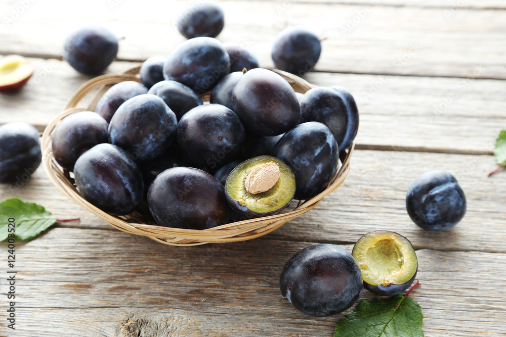 Tasty and ripe plums on grey wooden table Tasty and ripe plums on grey wooden table