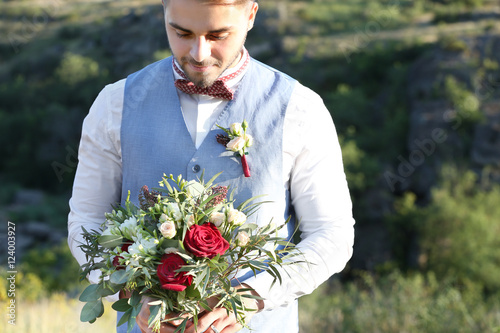 Groom standing over beautif...