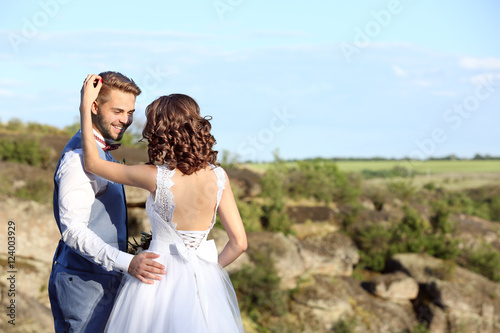 Bride and groom standing ov...