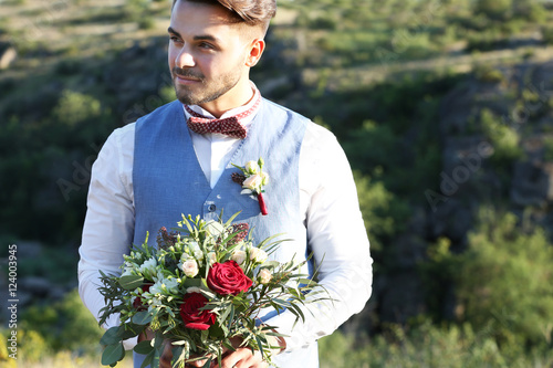 Groom standing over beautif...