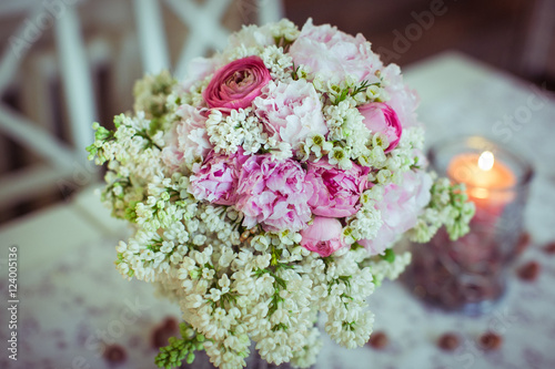 Pink peonies put in a bouquet full of white flowers