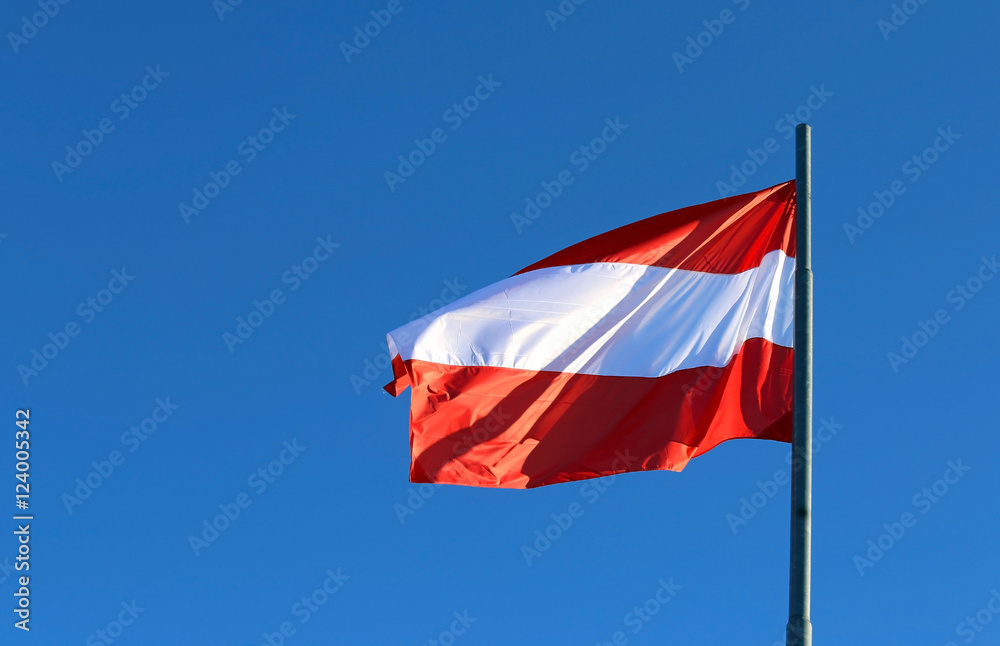 great Austrian flag waving in the blue sky great Austrian flag waving in the blue sky