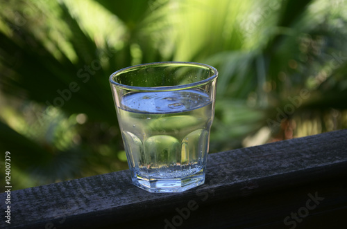 Ice cold water cup on the exotic background