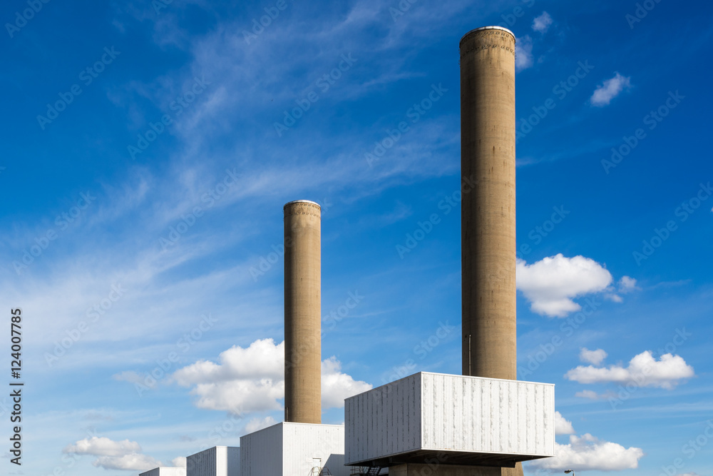 Chimneys of a coal fired power station against blue sky Chimneys of a coal fired power station against blue sky