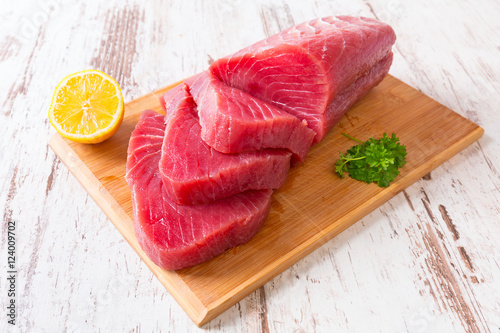 Raw tuna steak on wooden cutboard