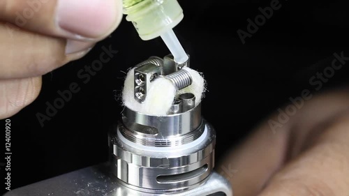 dripping e juice e liquid to new dual kanthal micro coils and organic cotton on atomizer’s deck base of electronic cigarette for vaping, close up scene, high definition, Full HD, 1920x1080