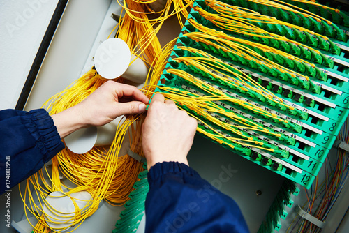 internet connection. engineer connecting fiber optic cables photo