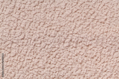 Light brown fluffy background of soft, fleecy cloth. Texture of textile closeup.