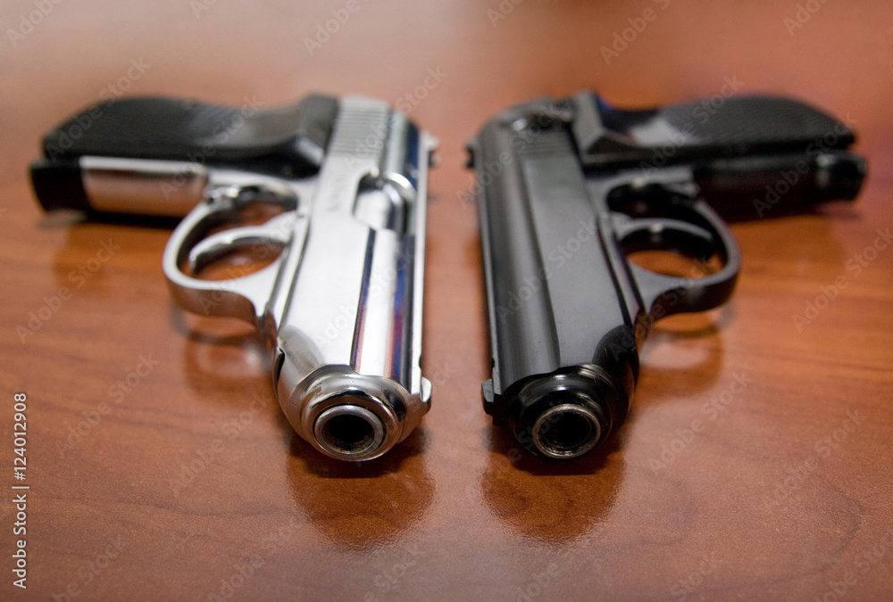 Two pistols on a table Two pistols on a table