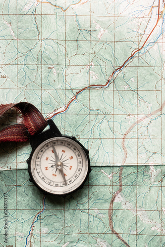 wanderlust and explore concept, old compass lying on map, top vi