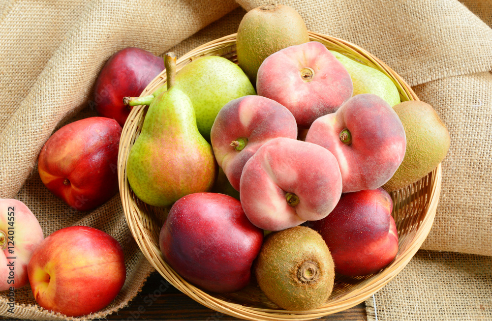 Dough nut peach,European Pear,Kiwifruit,nectarines in basket on sack cloth back ground.
a variety of fruits in summer.
Dough nut peach,European Pear,Kiwifruit,nectarines in basket on sack cloth back ground.
a variety of fruits in summer.