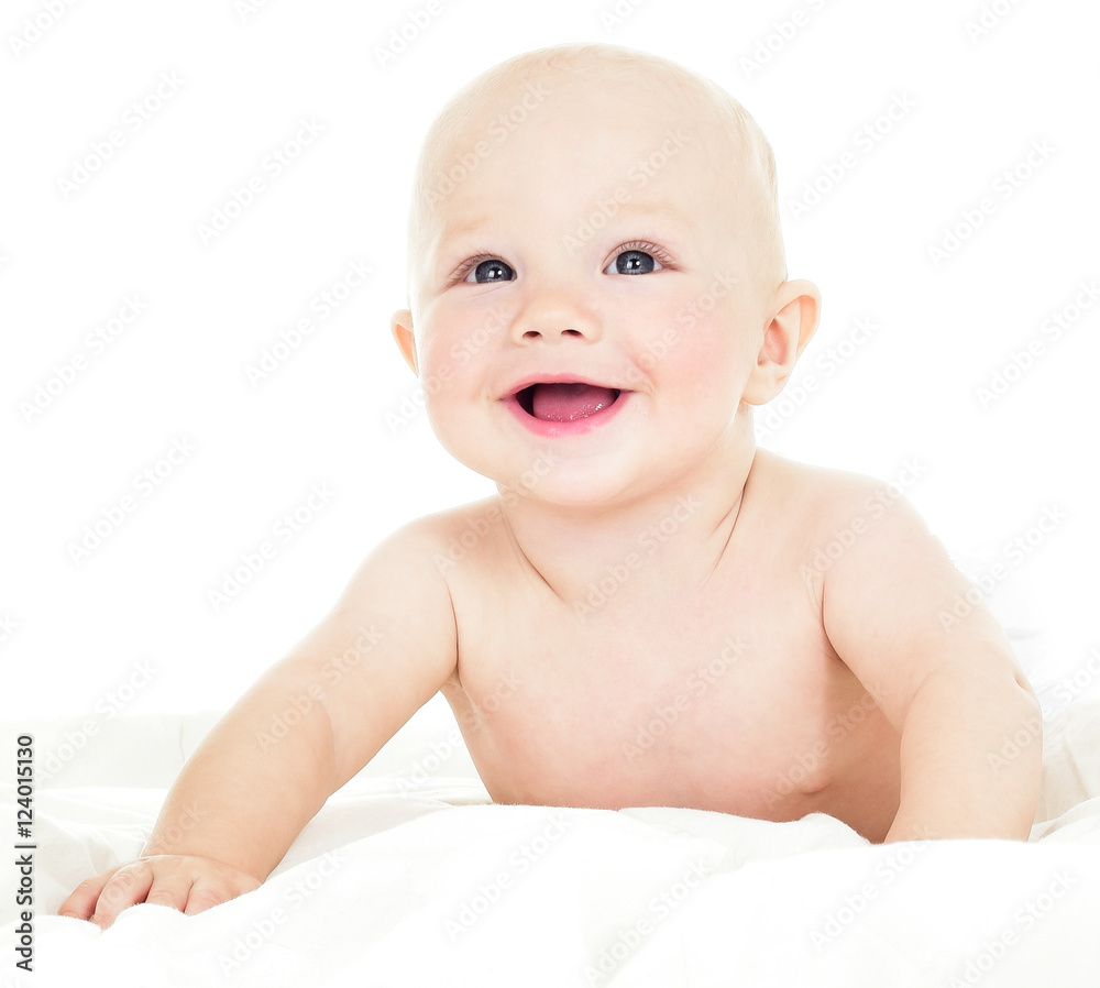 Beautiful smiling baby lying on his stomach in bed. One, isolate Beautiful smiling baby lying on his stomach in bed. One, isolate