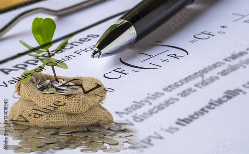 Investment valuation concept.Double Exposure of sprout growing from coins in money bag and Pen on Discount cash flow model background.