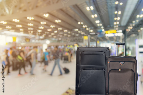 Closeup group of luggage in the airport terminal with the blurred peoples background.