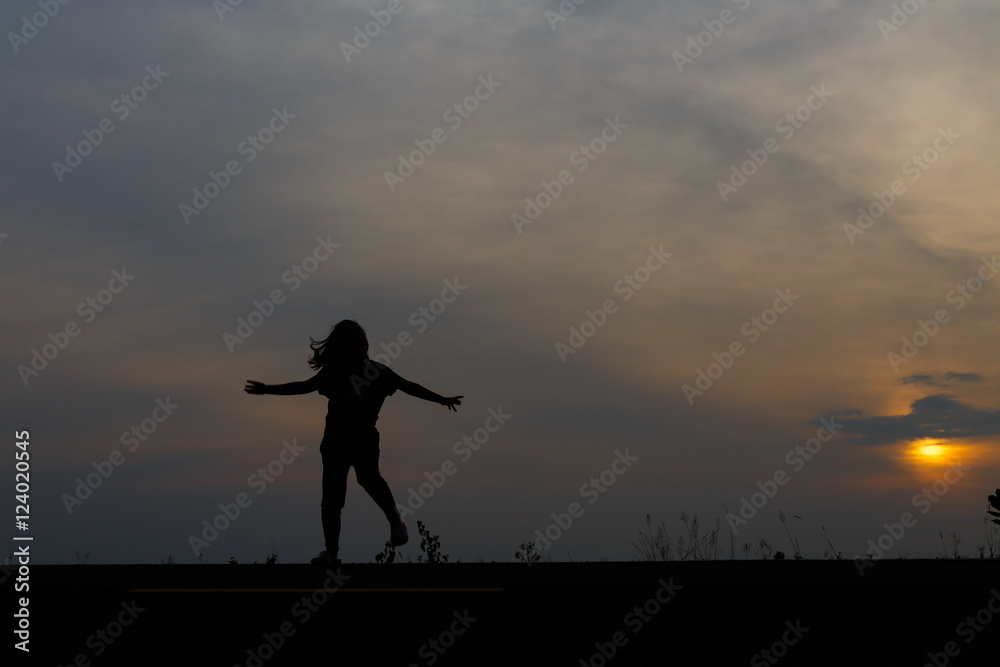 Silhouette girls on holiday. she is happy to be running and jump Silhouette girls on holiday. she is happy to be running and jump