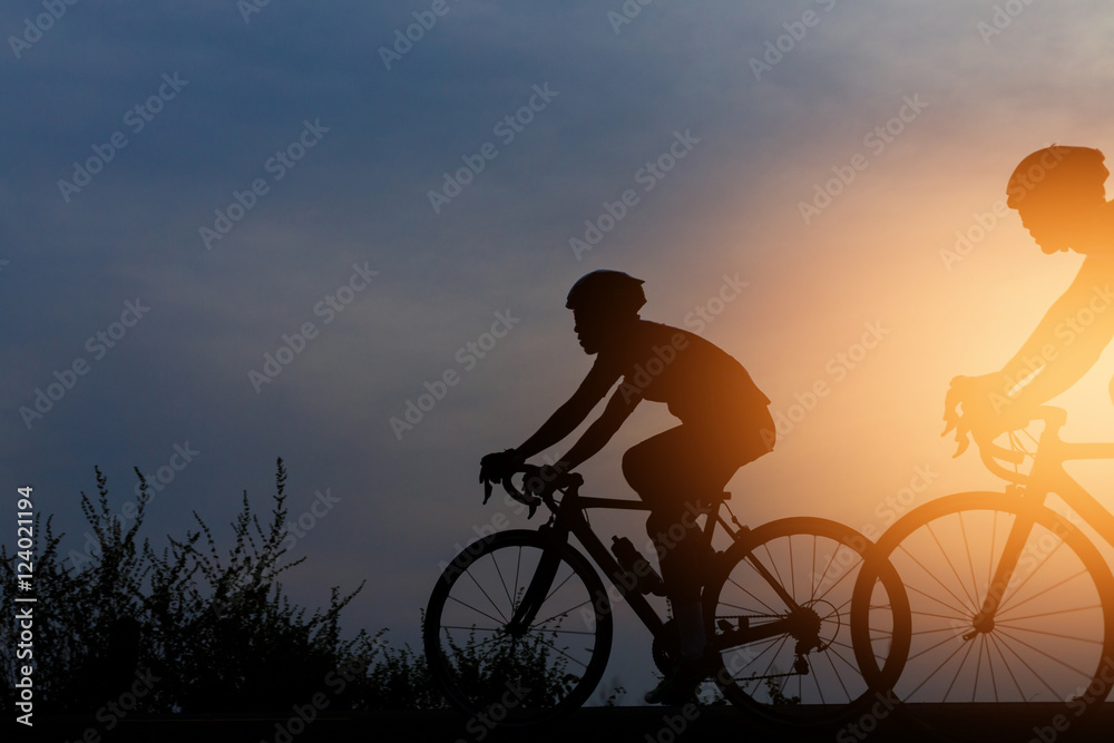 Silhouette cyclists at sunset Silhouette cyclists at sunset
