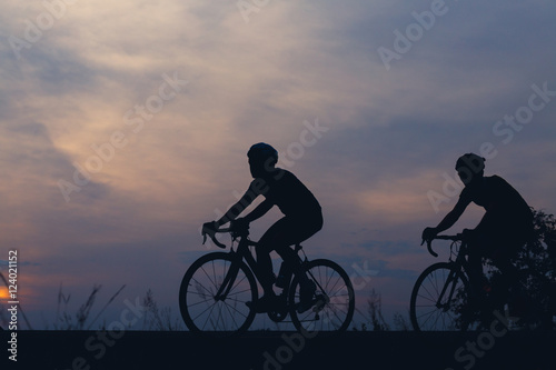 Fototapeta Naklejka Na Ścianę i Meble -  Silhouette cyclists at sunset