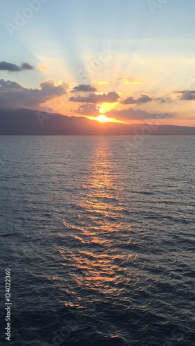 Sunset at Sea , Ocean Sunset, Traquil Ocean, View from Cruise Sunset over the moutains © Eric