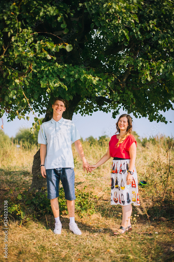 Fototapeta premium Romantic Beautiful young couple walking in autumn park