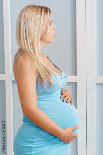 Free Download  pregnant woman in blue dress near the window - GFXLoad