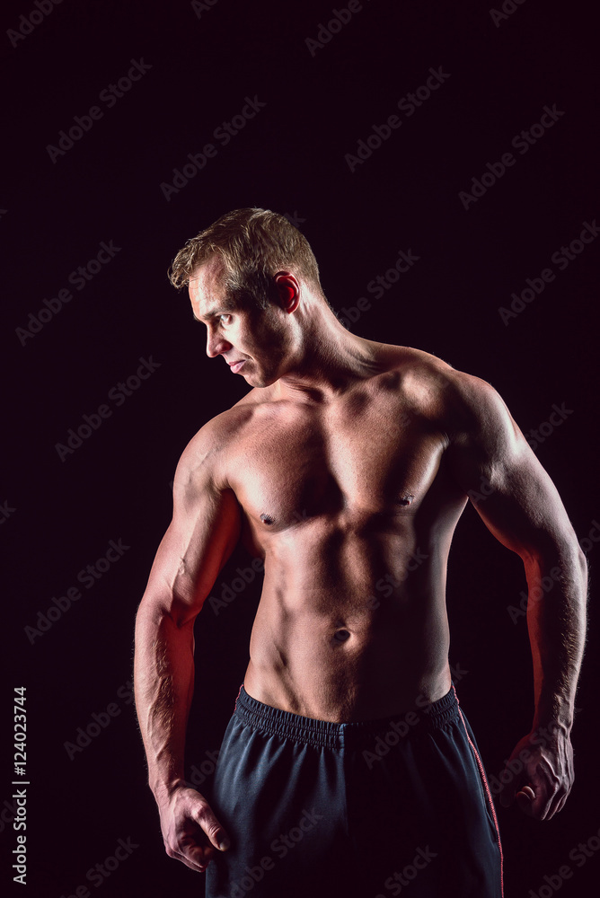Muscular, strong and sexy man isolated on black background Muscular, strong and sexy man isolated on black background