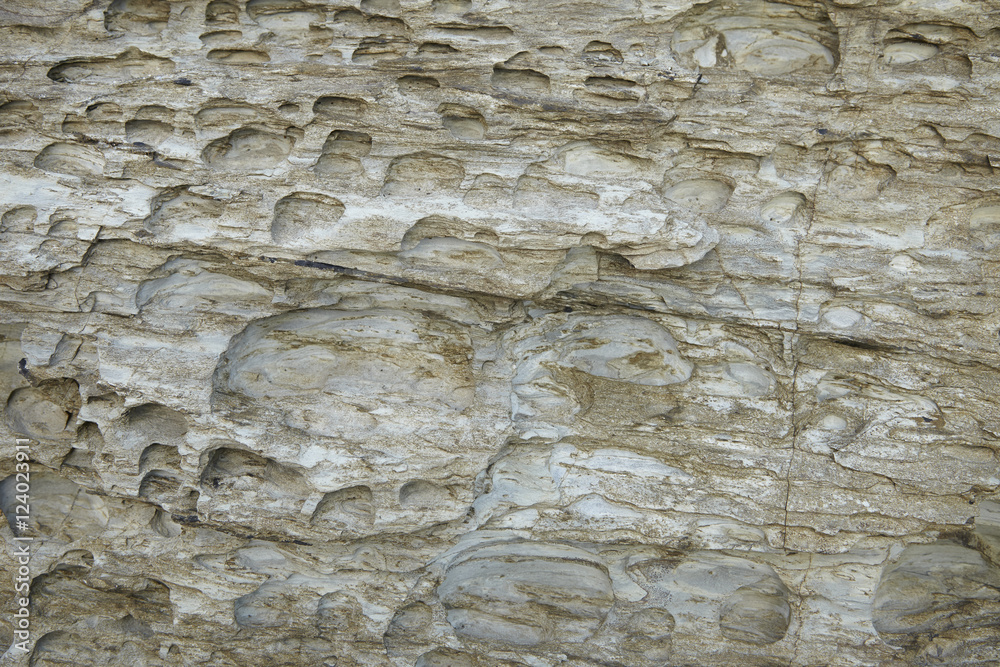 A full page of white rock with eroded holes background texture