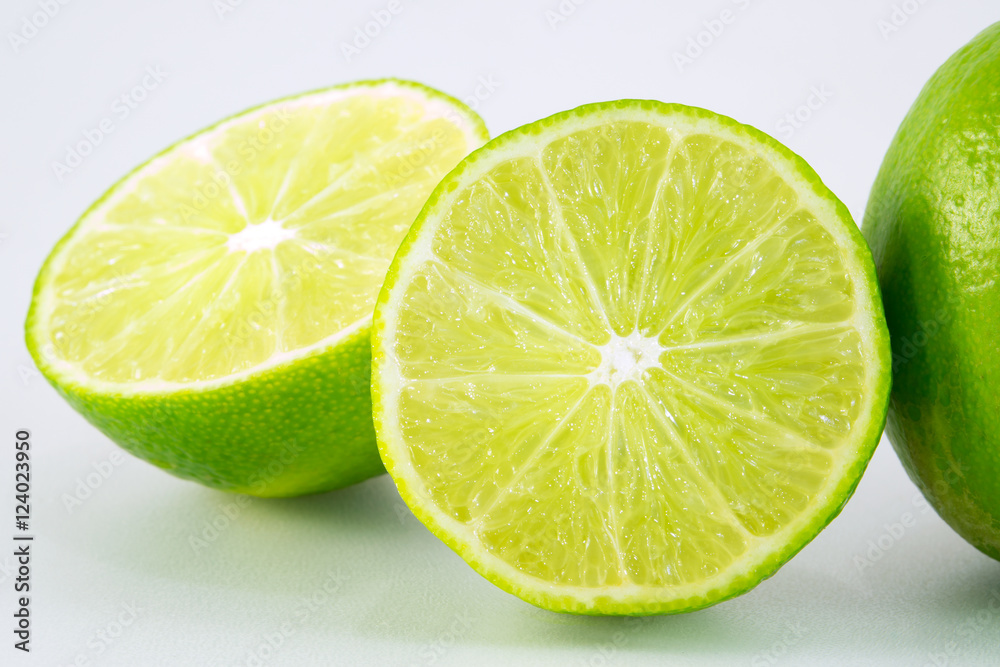 slice of fresh lime on white background slice of fresh lime on white background