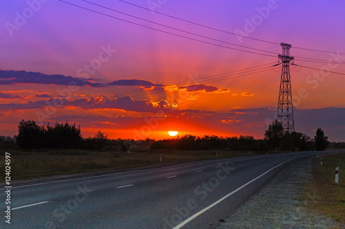 Electricity tower and power lines on sunset background. Beautiful industrial landscape and sunset. Electricity distribution.