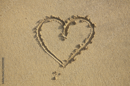 Aerial view of a love heart drawn in wet sand on the beach