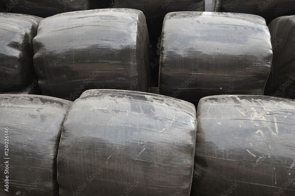 A whole page of black farm straw bails background texture A whole page of black farm straw bails background texture