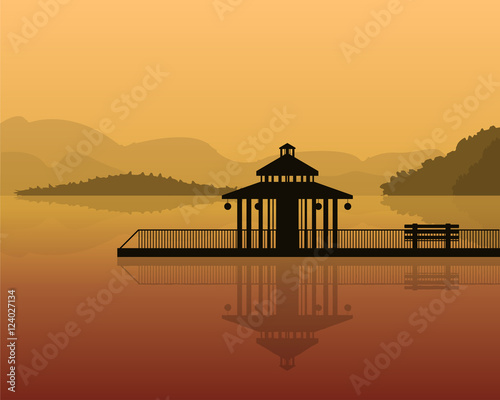 landscape - silhouette of a house on a background of mountains, sky with reflection in water.