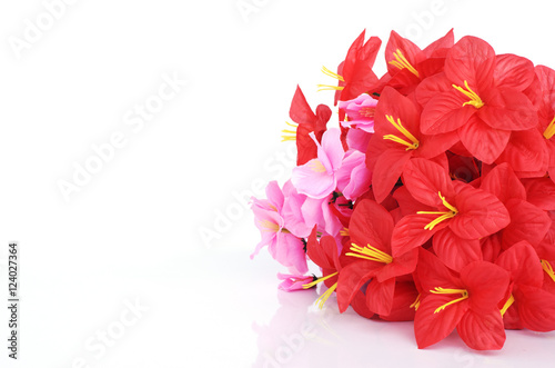 Red and pink plastic flowers Ioslated on white backgrounds