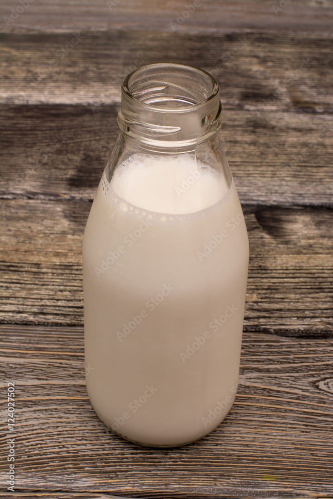 Bottle of milk on wooden background Bottle of milk on wooden background