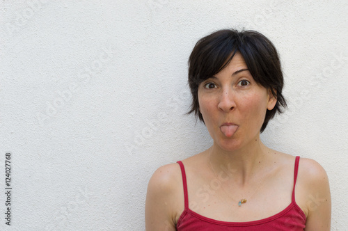 Childish Woman Standing in Front of a Wall