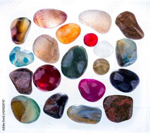 Collection of Colorful Semiprecious Gemstones on White Background.