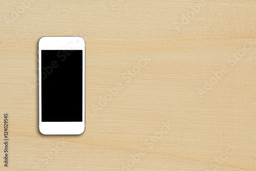 Top view smartphone mock up template with black screen on wooden table with copyspace.