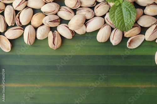 Pistachio nuts is tasty on wood background.