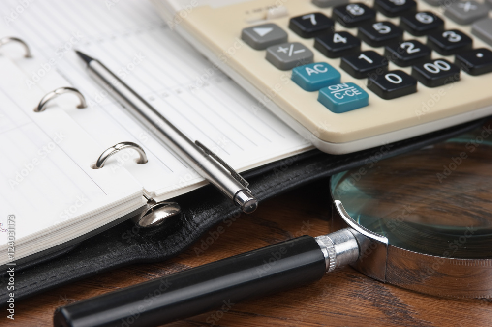 pen, magnifying glass and diary pen, magnifying glass and diary
