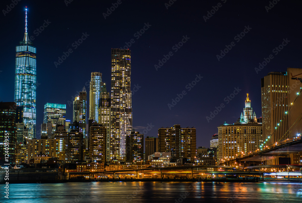 Night view of the skyscrapers of New York City from the Brooklyn Bridge Park. Night view of the skyscrapers of New York City from the Brooklyn Bridge Park.
