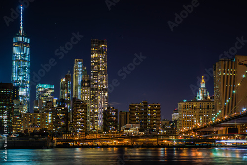 Night view of the skyscrapers of New York City from the Brooklyn Bridge Park. © Overburn