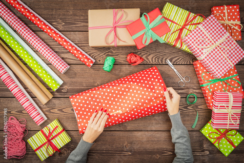 Female hands wrapping christmas presents