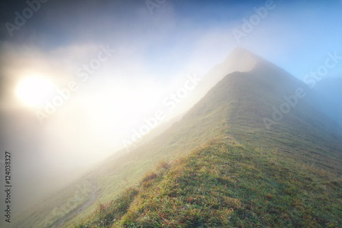 foggy sunrise by mountain top