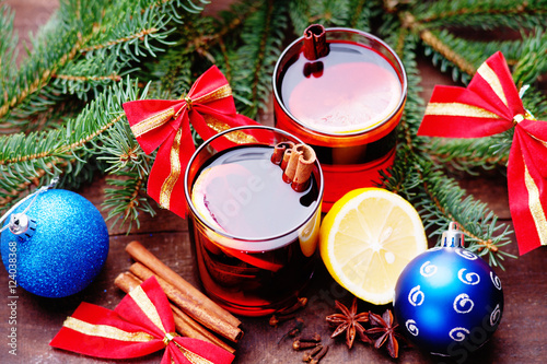 Hot mulled wine with spices, lemon and christmas balls 